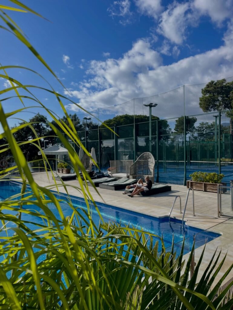 Padel courts behind the pool at Royal Tennis Club Marbella in El Rosario