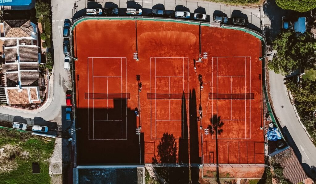 Aerial view of the clay and hard courts at CAP Racket Club in Marbella